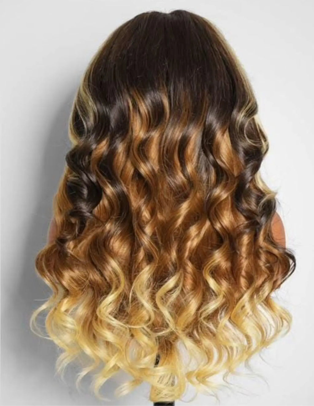 Back view of a highlight Burmese curly human hair wig with full density and natural curl definition.