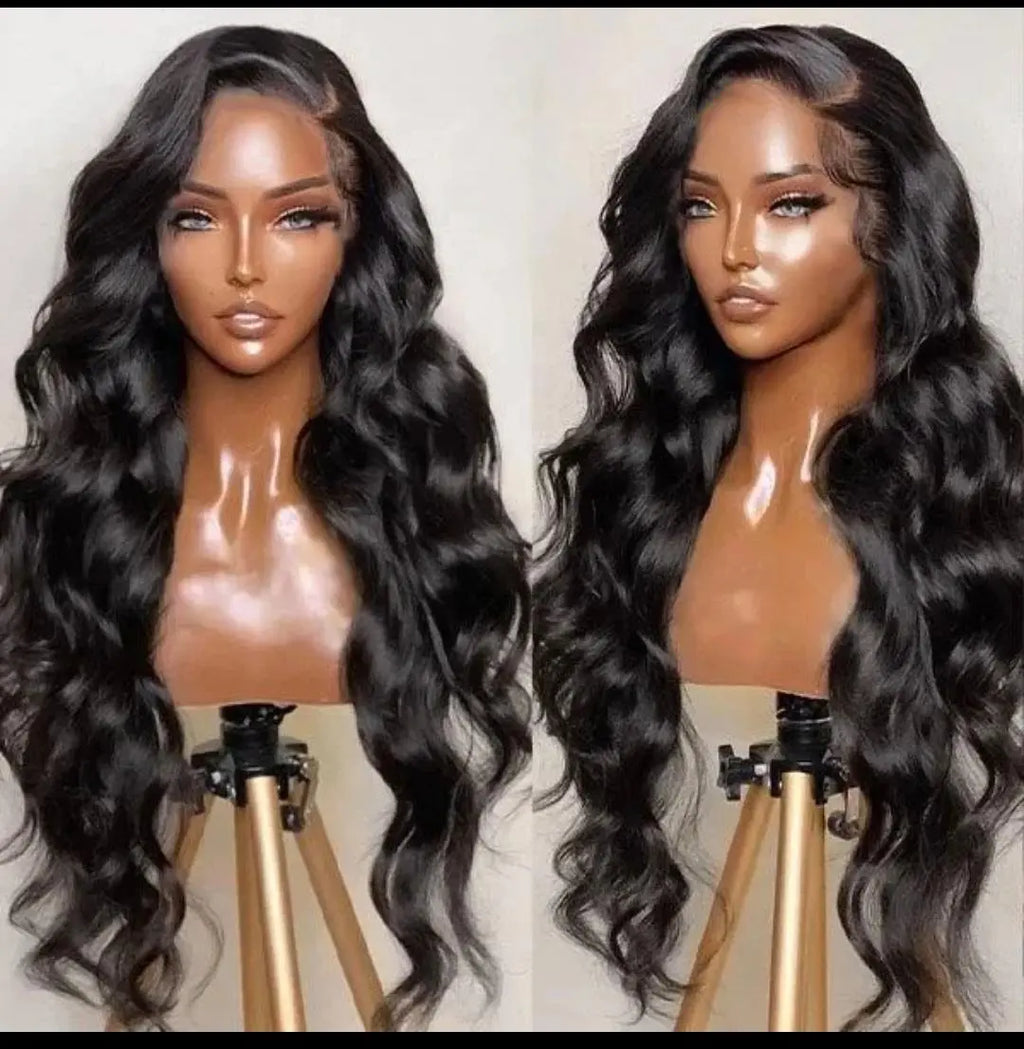 Two mannequin heads with long, wavy black hair on beige backgrounds.