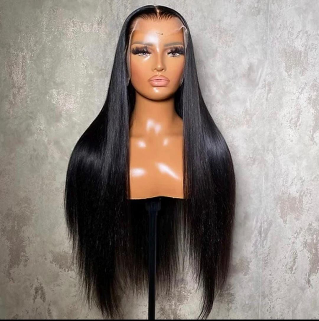 Black straight wig on a mannequin head against a gray background