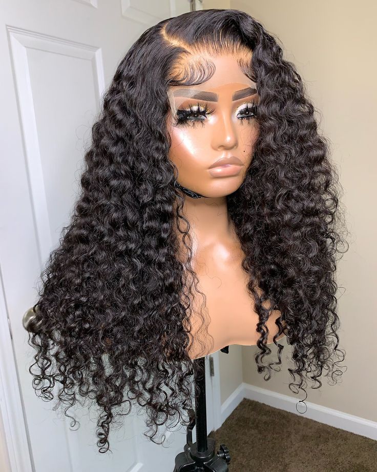 Curly wig on a mannequin head against a neutral background